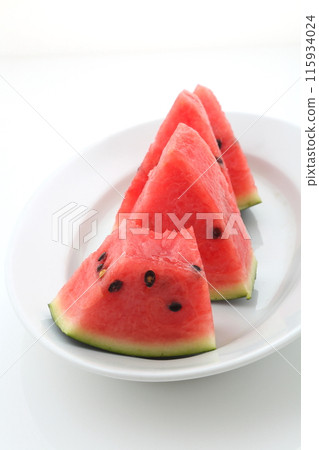 Half-eaten triangular cut of black watermelon 115934024