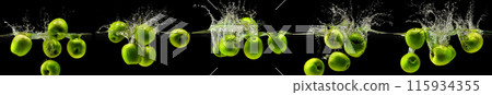 Green apple falling in water on black background Green apple falling in water on black background 115934355