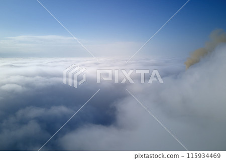 Coal power plant high pipes emitting black poisonous smoke moving upwards over white fog polluting air. Production of electrical energy with fossil fuel concept 115934469
