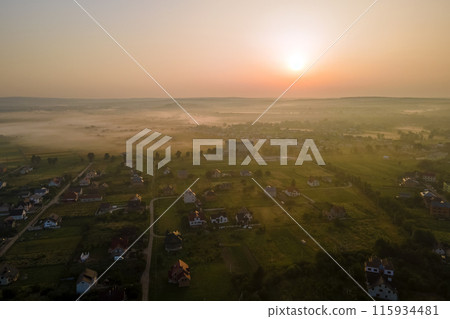 Aerial view of residential houses in suburban rural area at sunset Aerial view of residential houses in suburban rural area at sunset 115934481