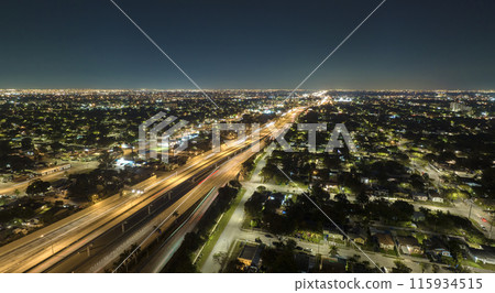 Aerial view of american highway junction at night with fast driving vehicles in Miami, Florida. View from above of USA transportation infrastructure 115934515