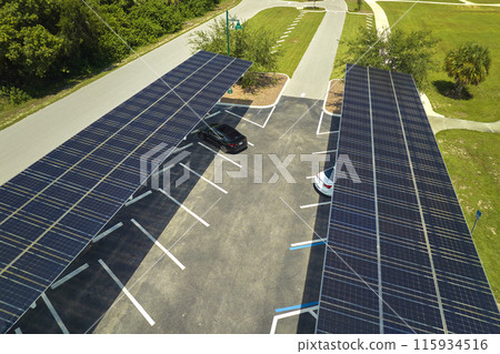 Solar panels installed over parking lot for parked cars for effective generation of clean energy 115934516
