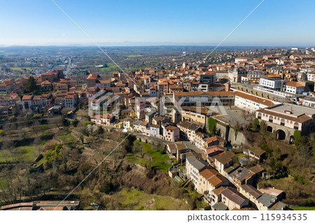 Aerial view of dense historic center of Thiers town in Puy-de-Dome department, Auvergne-Rhone-Alpes region in France. Rooftops of old buildings and narrow streets 115934535