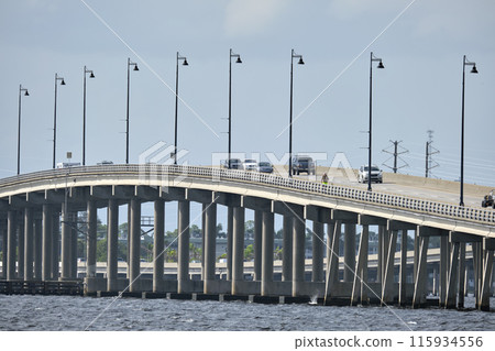 Barron Collier Bridge and Gilchrist Bridge in Florida with moving traffic. Transportation infrastructure in Charlotte County connecting Punta Gorda and Port Charlotte over Peace River 115934556