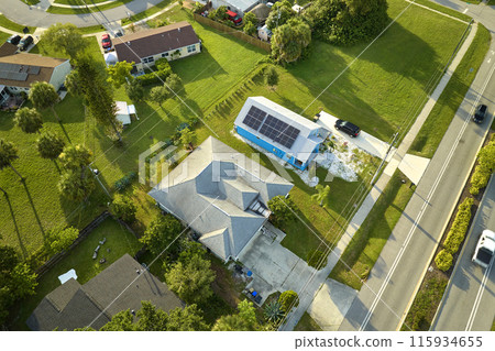 Aerial view building roof with rows of blue solar photovoltaic panels for producing clean ecological electric energy. Renewable electricity with zero emission concept 115934655