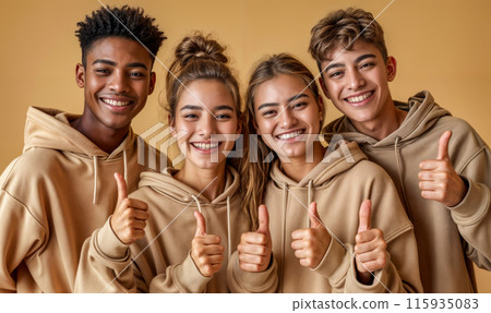 Four young people are smiling and giving thumbs up to the camera Four young people are smiling and giving thumbs up to the camera 115935083