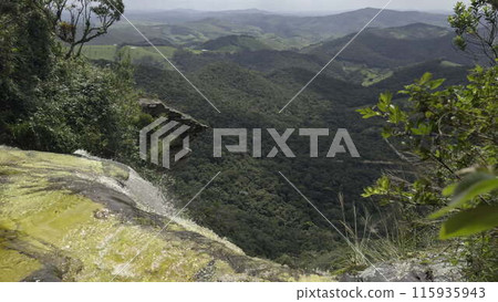 Aerial Slow-Motion Waterfall with Reddish Hue in Lush Jungle 115935943