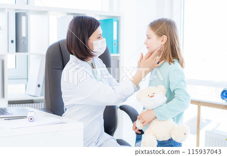Doc checking lymph nodes of little patient 115937043