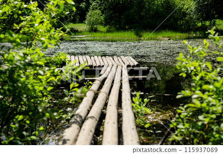 Old wooden pier, deck, bridge on pond, lake in nature, summer day landscape Old wooden pier, deck, bridge on pond, lake in nature, summer day landscape 115937089