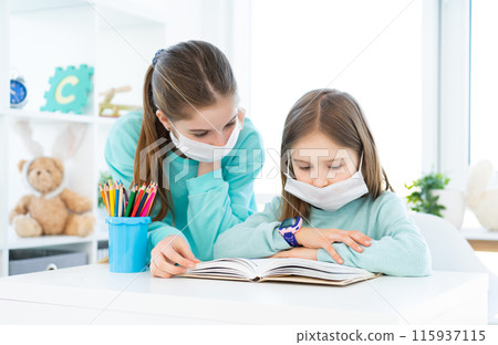 Home schooling of cute sisters during pandemic 115937115