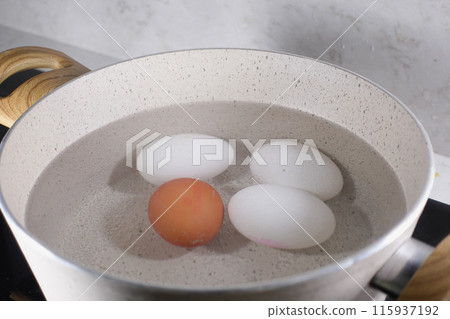 Boiled eggs in a saucepan on ceramic hob Boiled eggs in a saucepan on ceramic hob 115937192