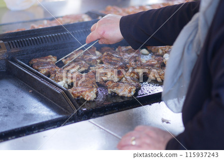 Beef and chicken steaks on the grill with flames. 115937243