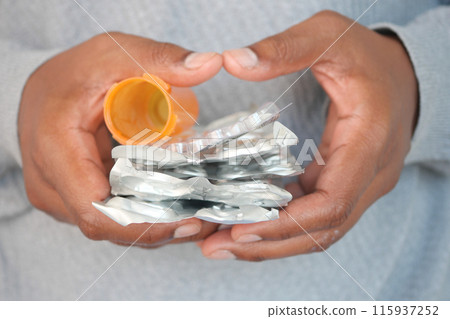 man holding empty pills of blister pack man holding empty pills of blister pack 115937252