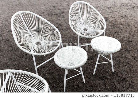 Wet white furniture of street cafe stand on the ground Wet white furniture of street cafe stand on the ground 115937715