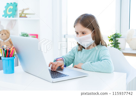 Cute little girl studying at home during quarantine 115937742