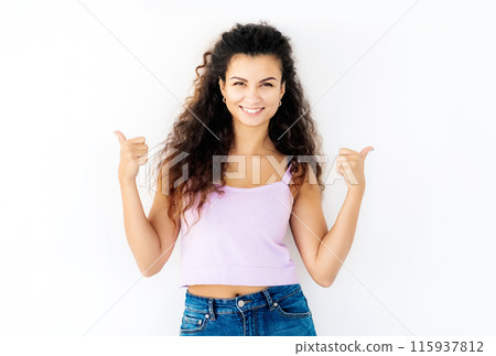 Naughty young girl showing thumbs up Naughty young girl showing thumbs up 115937812