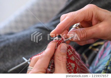Close up of the hands of an woman knitting sock 3 115937857
