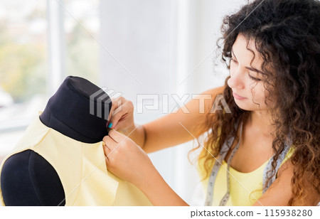 Close up view of hands sewing with needle Close up view of hands sewing with needle 115938280