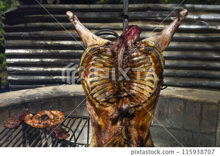 Lamb on the spit, cooked with the traditional Argentine method, La Pampa province, Patagonia, Argentina. 115938707