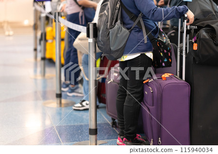 People with suitcases at the airport 115940034