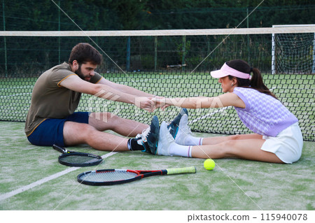 Tennis Players Stretching Hand In Hand Tennis Players Stretching Hand In Hand 115940078