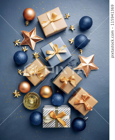 A festive arrangement of gifts and ornaments on a blue backdrop 115941369