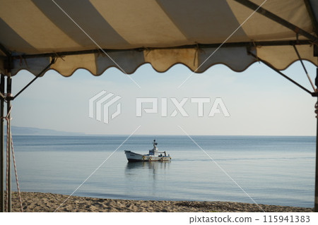 A fishing boat floating in the sea 115941383