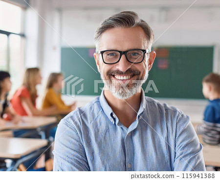 Smiling Confident Male Teacher in Classroom with Attentive Students and Blackboard Background 115941388