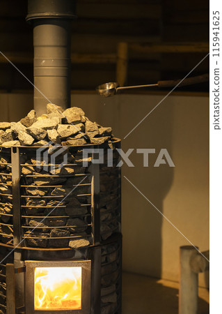 Firewood burning in a sauna stove 115941625