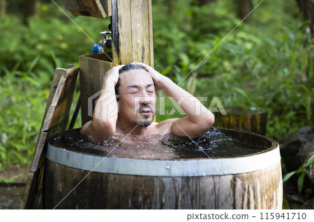 A man in his 50s enjoying a cold bath A man in his 50s enjoying a cold bath 115941710