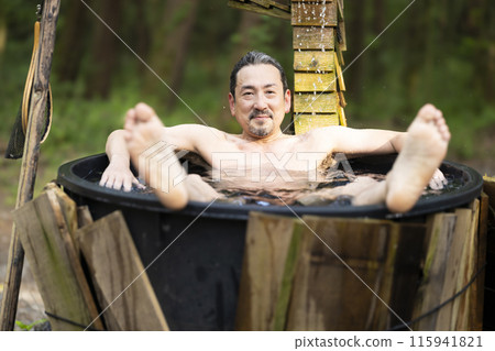 A man in his 50s enjoying a cold bath A man in his 50s enjoying a cold bath 115941821