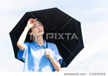 A young woman walking with a parasol Lifestyle image 115943029
