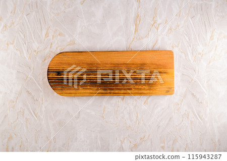 Wooden cutting board on a gray marble background 115943287