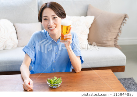 Young woman drinking beer lifestyle image 115944883