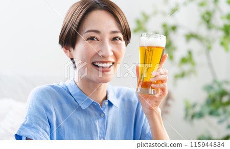 Young woman drinking beer lifestyle image 115944884