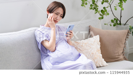 Pregnant woman operating a smartphone Lifestyle image 115944935