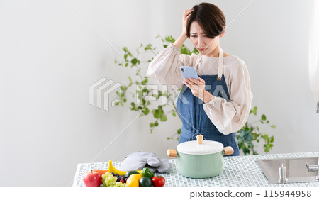 A young woman cooking in an apron Lifestyle image 115944958