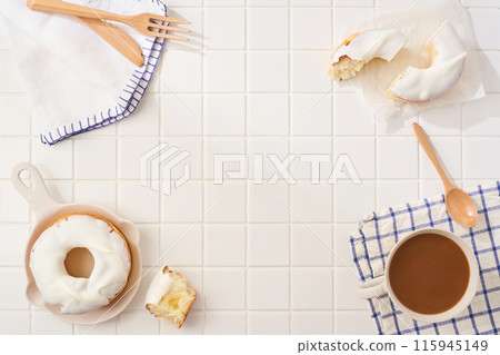 A delicious moment with white icing donuts and cafe au lait A delicious moment with white icing donuts and cafe au lait 115945149