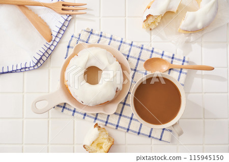 A delicious moment with white icing donuts and cafe au lait A delicious moment with white icing donuts and cafe au lait 115945150