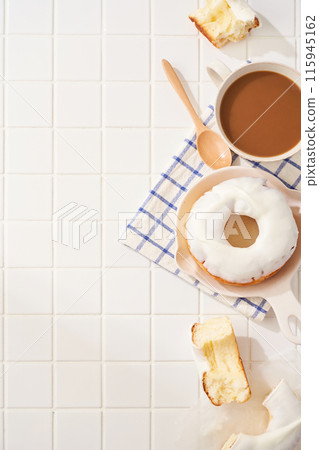 A delicious moment with white icing donuts and cafe au lait 115945162