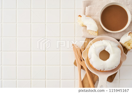 A delicious moment with white icing donuts and cafe au lait A delicious moment with white icing donuts and cafe au lait 115945167