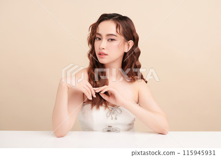 Beautiful young asian woman with clean fresh skin on beige background, Face care, Facial treatment, Cosmetology, beauty and spa, Asian women portrait. 115945931