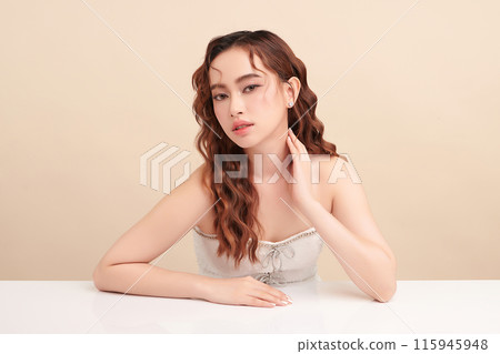 Beautiful young asian woman with clean fresh skin on beige background, Face care, Facial treatment, Cosmetology, beauty and spa, Asian women portrait. Beautiful young asian woman with clean fresh skin on beige background, Face care, Facial treatment, Cosmetology, beauty and spa, Asian women portrait. 115945948