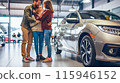 A happy family looking at and considering a new car they are about to purchase at an automotive showroom  The image depicts the exciting process of shopping for and selecting a new vehicle 115946152