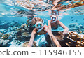 A family enjoys a fun filled vacation snorkeling in the crystal clear waters to discover a vibrant underwater world of coral reefs and diverse marine life during their tropical beach getaway 115946155