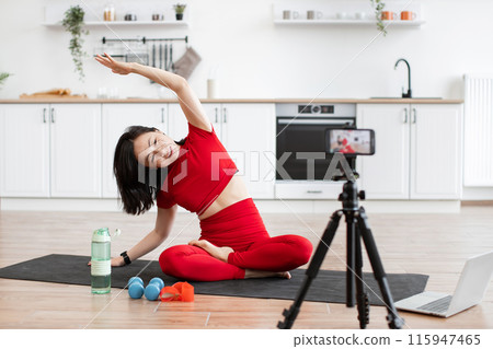 Woman practicing yoga at home on fitness mat in kitchen Woman practicing yoga at home on fitness mat in kitchen 115947465