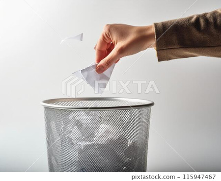 Hand throwing trash in a trash can Hand throwing trash in a trash can 115947467