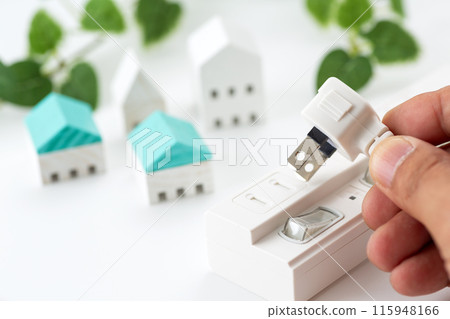 Hands of a man unplugging a power strip 115948166