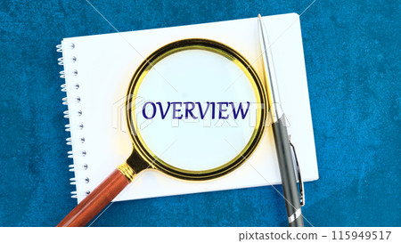 Conceptual overview word symbol. Copy space. Overview word written through a magnifying glass on a piece of notepad 115949517