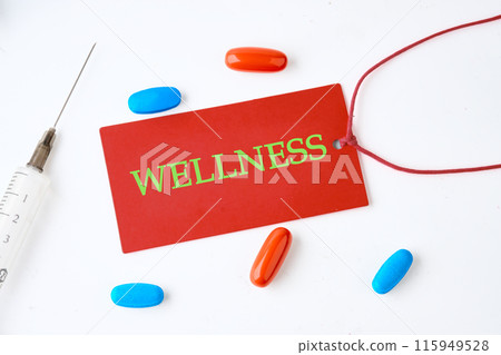Wellness sign on a red card on a light background with pills in the composition 115949528